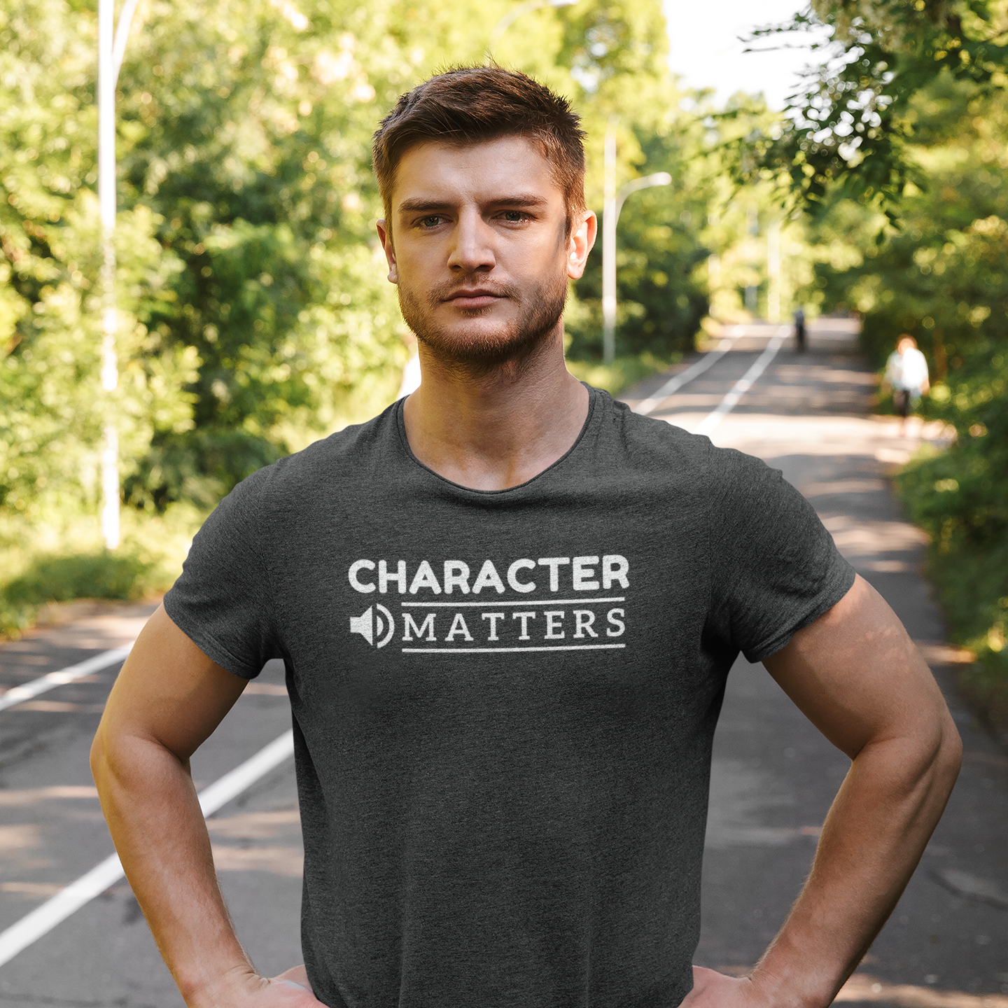 Motivational workout shirt with text Character Matters worn by a fit man exercising on the tracks