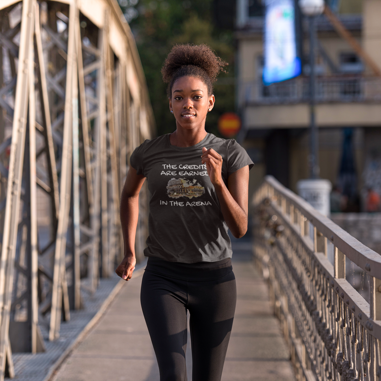The Credits Are Earned In The Arena by doing your best motivational workout shirt on a woman jogging in an urban setting