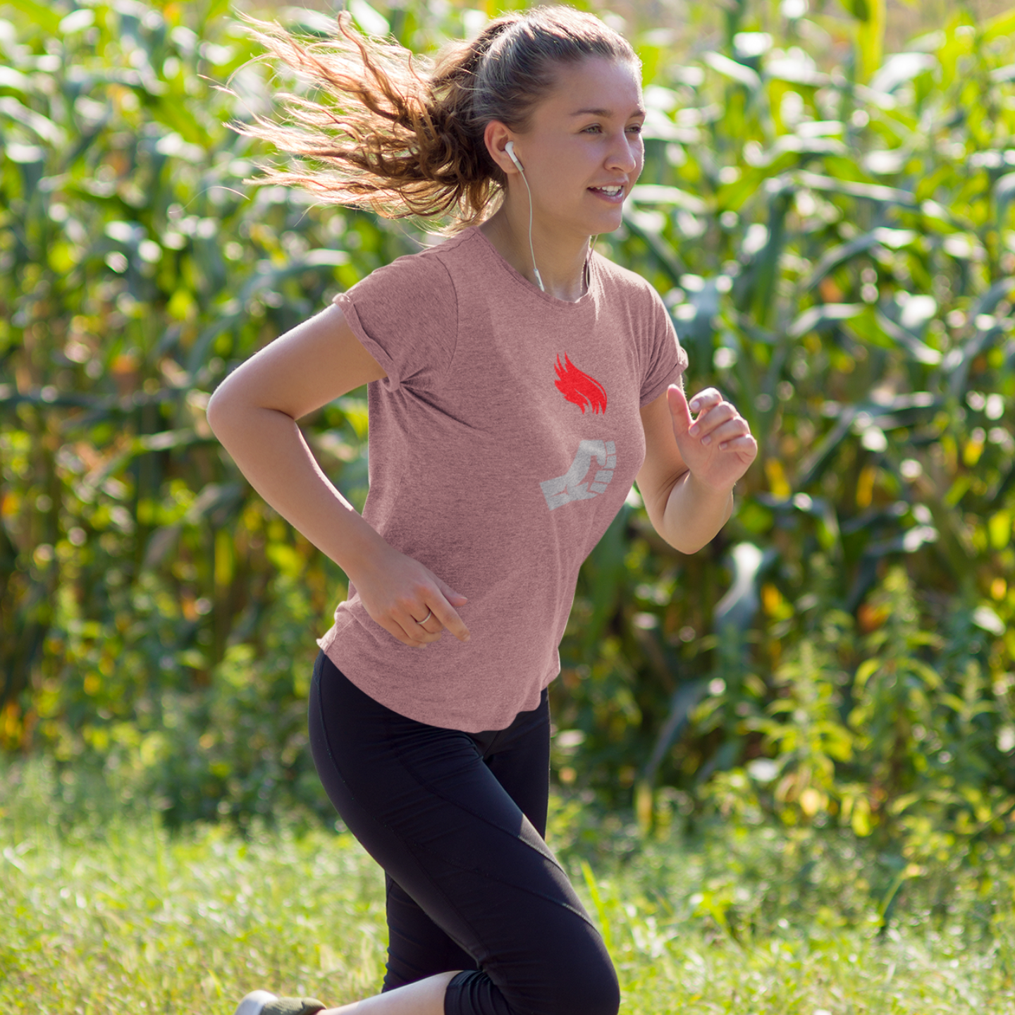 Torchbearer graphic workout shirt in heather mauve pink pale purple rose gold color worn by a female runner training outdoors